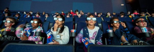 kids wearing 3d glasses at the imax theater