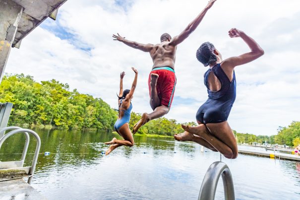 two girls and their father jump into Wakulla Springs