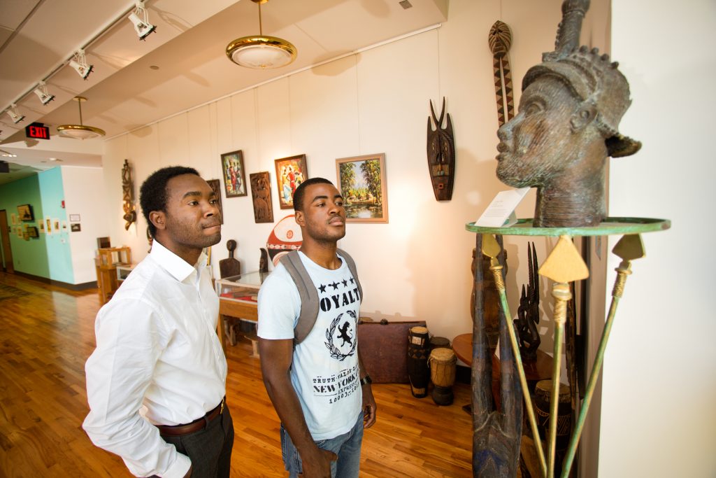 two men looking at art in the black archives ats famu