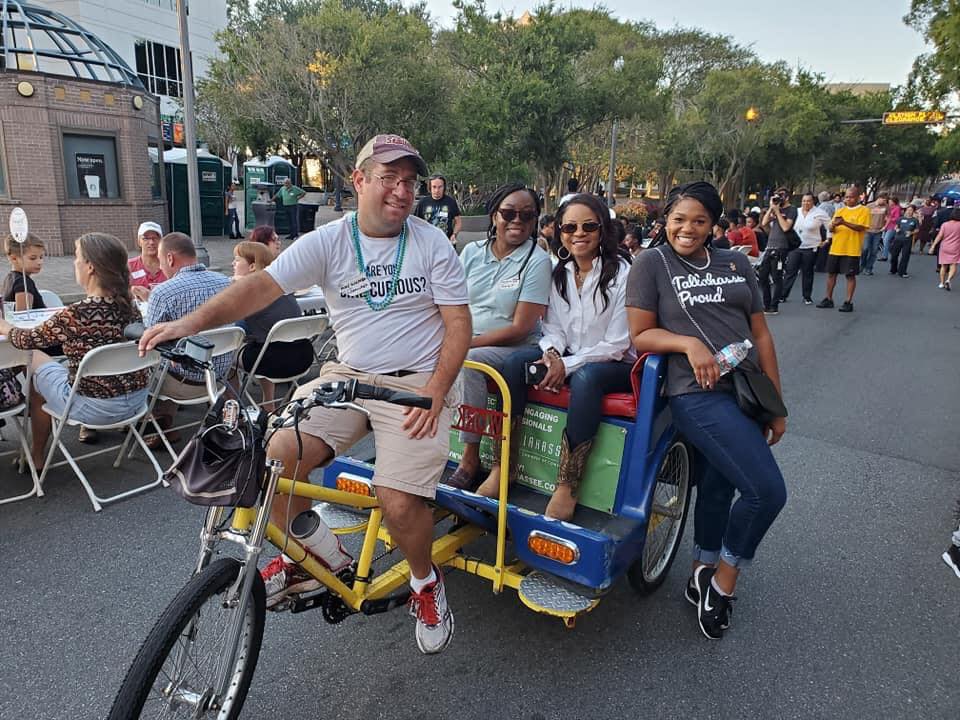 three people on a pedicab