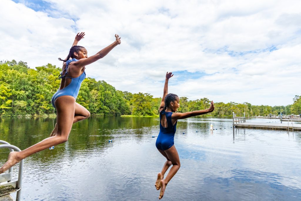 two girls jump into wakulla springs